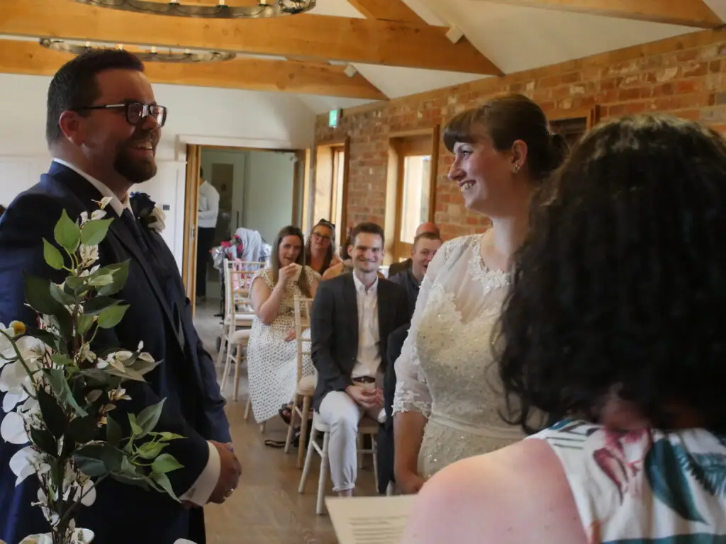 Image of a marriage ceremony with the couple laughing