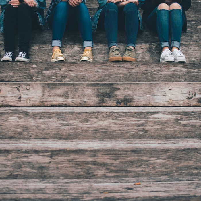 Teenagers siting on a wooden step